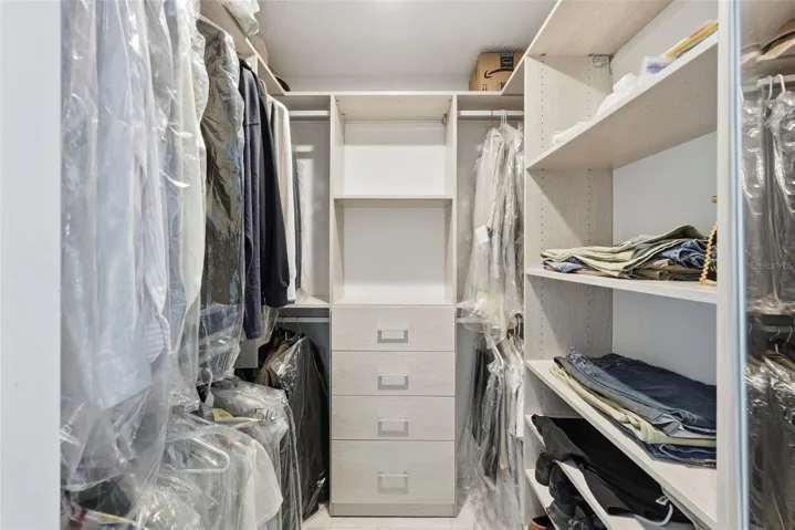 Primary closet with new California Closet system.
