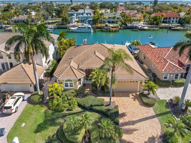 Home for your yacht! This updated waterfront home offers a 45ft wet slip as well as a 13000lb lift!