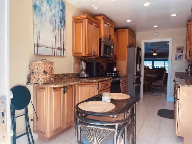 Standing by the sliders with the view through your kitchen, back out into the dining room!