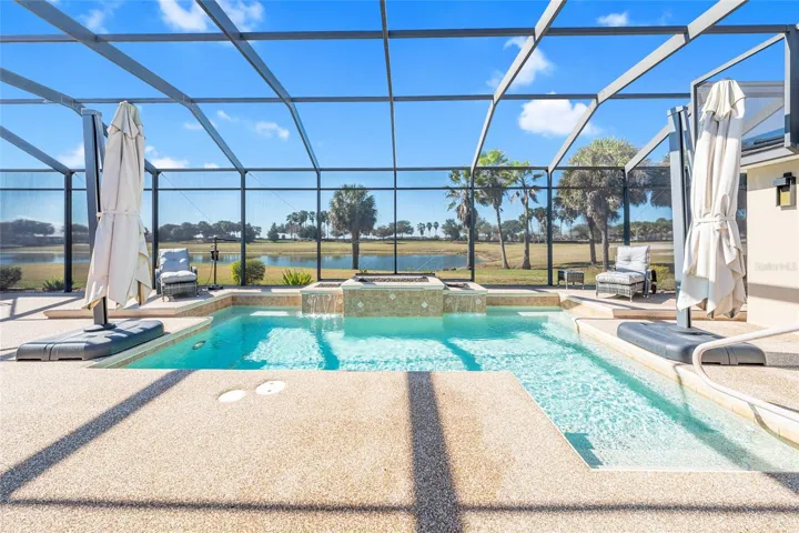 View of POOL w/ two large portable umbrellas