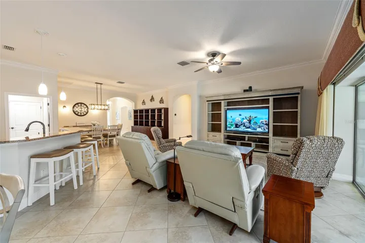 View of MAIN LIVING area from Breakfast Nook - Shows KITCHEN (front L), INTERIOR LAUNDRY (back L), DINING ROOM (back L center), archway entrance to FOYER & GUEST WING, and archway entrance to PRIMARY BEDROOM (back center R)