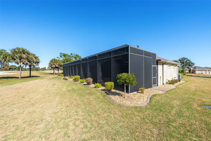 REAR EXTERIOR view - Shows SW corner of BIRDCAGE w/ privacy screens visible on lower half of structure.