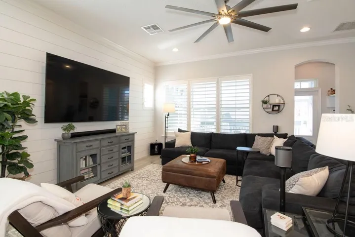 LIVING ROOM WITH CUSTOM SHIPLAP, CROWN MOLDING AND DESIGNER FAN