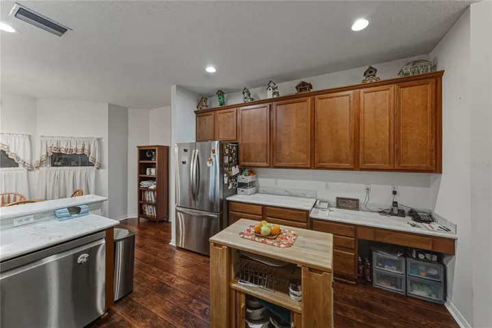 The kitchen has a built-in desk area.