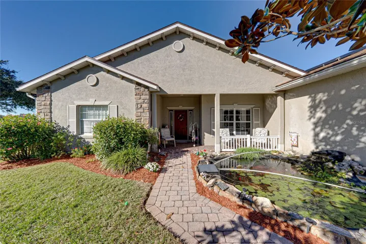 A tranquil koi pond is at the front of the home and is enjoyed from the covered front porch.