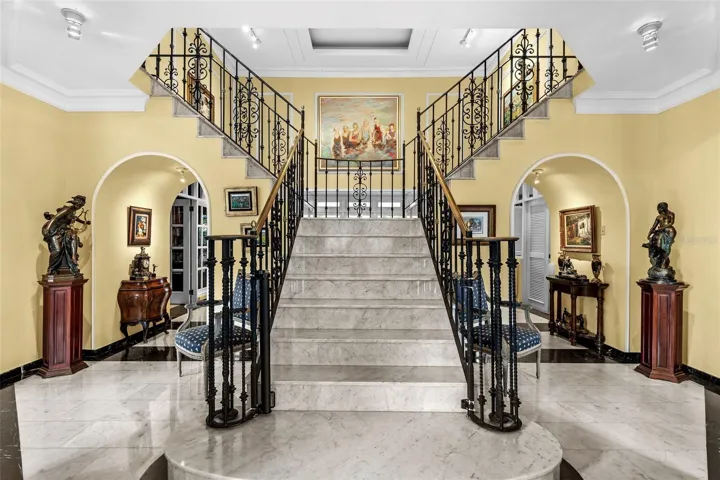 A grand, double-height entryway with a sweeping staircase that sets the tone for elegance throughout the home.