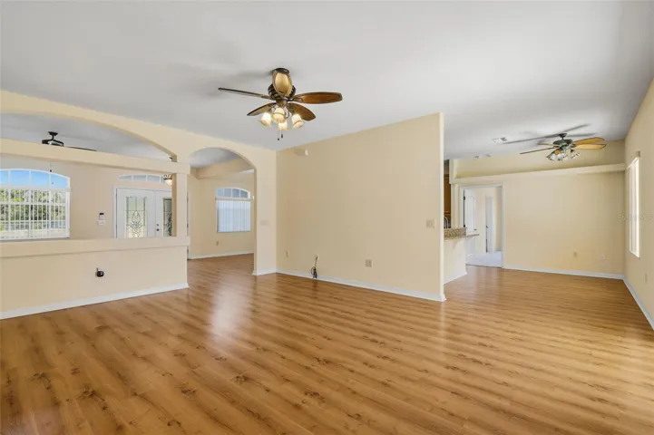 Family Room with an Arched pony wall separating from the Formal area.