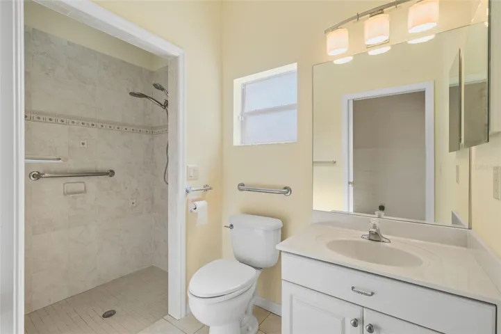 The Main Bath with a Roll-in Shower is close to the pool.