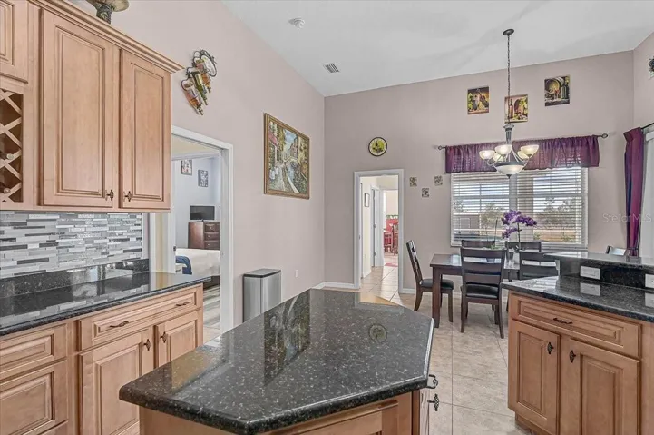 Large space for kitchen dining. The pocket door leads to a bedroom, bath room, and the huge Game room. Could easily become an in-law suite.