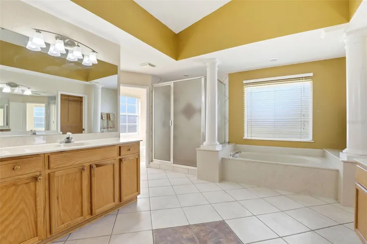 Primary Ensuite with Garden Tub, Walk-in Shower, Dual Sinks, Water Closet, and Two Walk-in Closets
