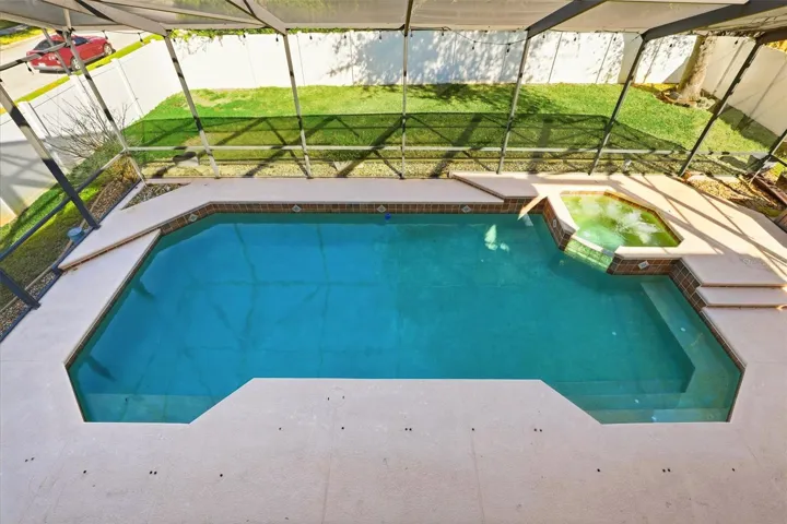 Large Screen Enclosed Pool Area with Spa, Built-in Safety Gate Holders, and LED lights.
