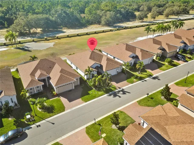 Home situated on a golf course with a beautiful wooded area backdrop.