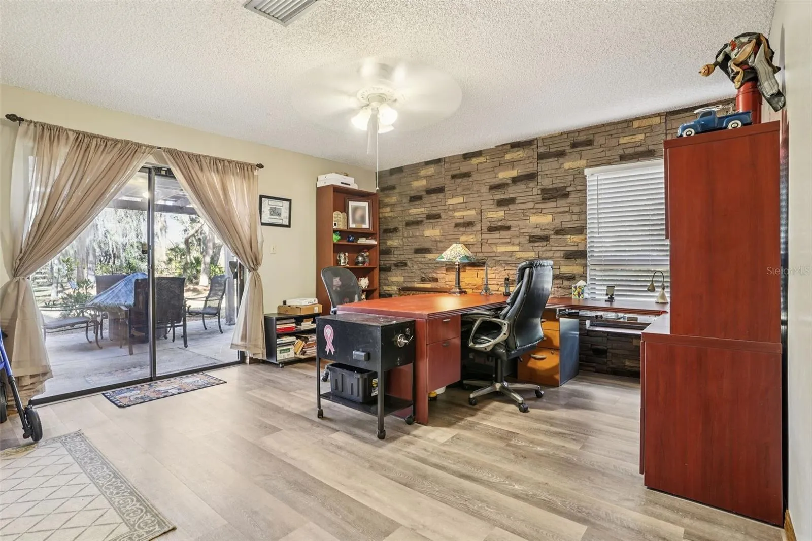Office with sliders and private patio. First Floor