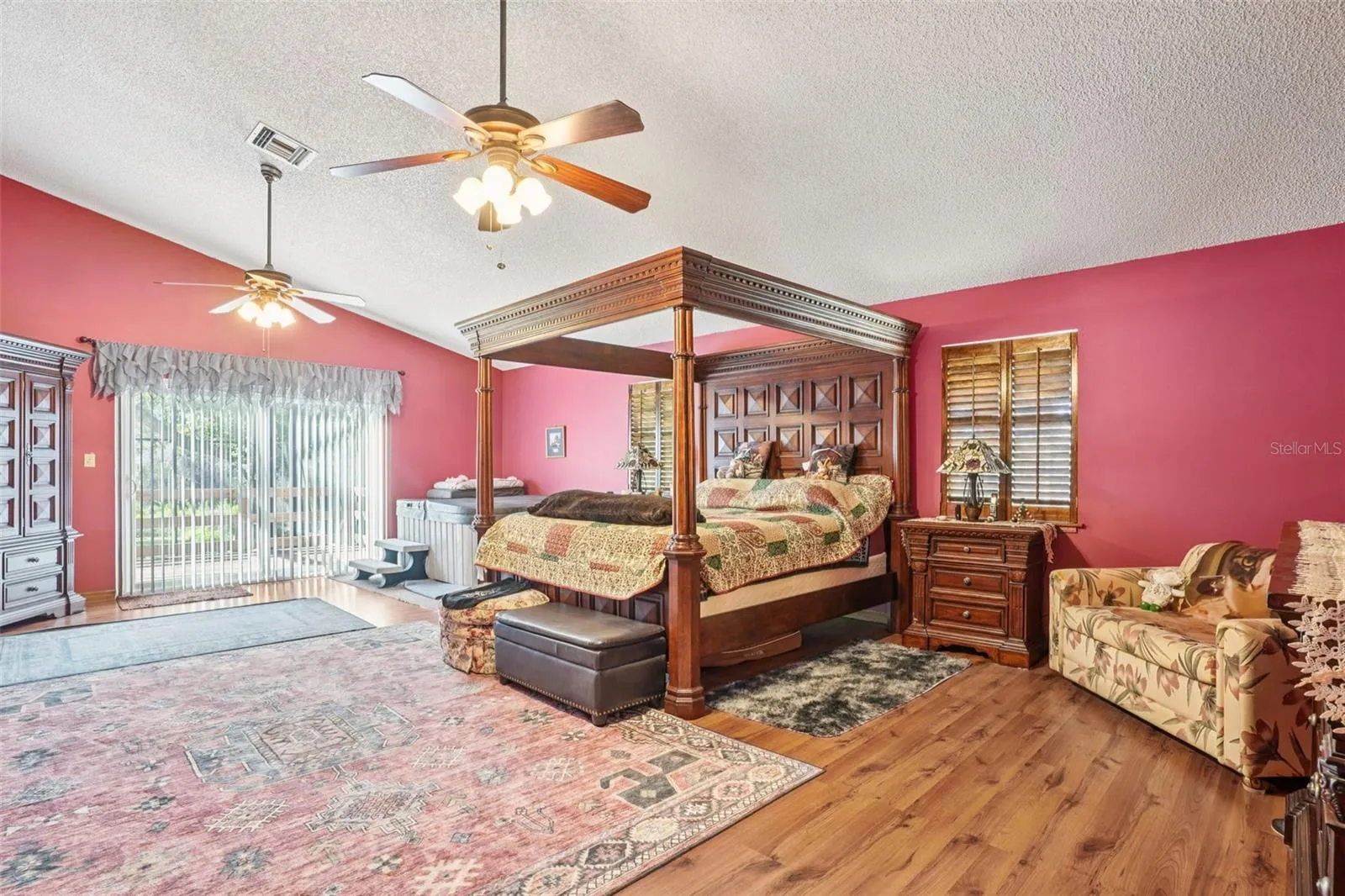 Primary suite - HUGE! Wood floors, walk-in closet, large balcony overlooking pool