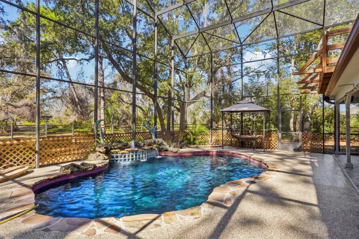 Expansive pool area with 2-storey height screen