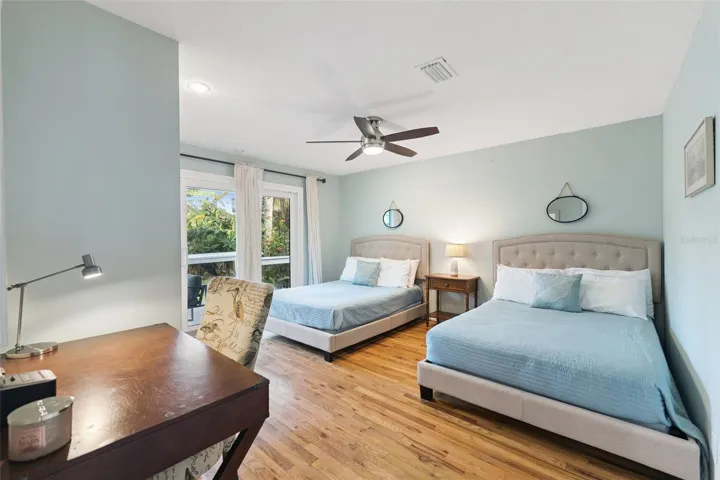 First floor, second bedroom with sliding door access to the pool and deck.