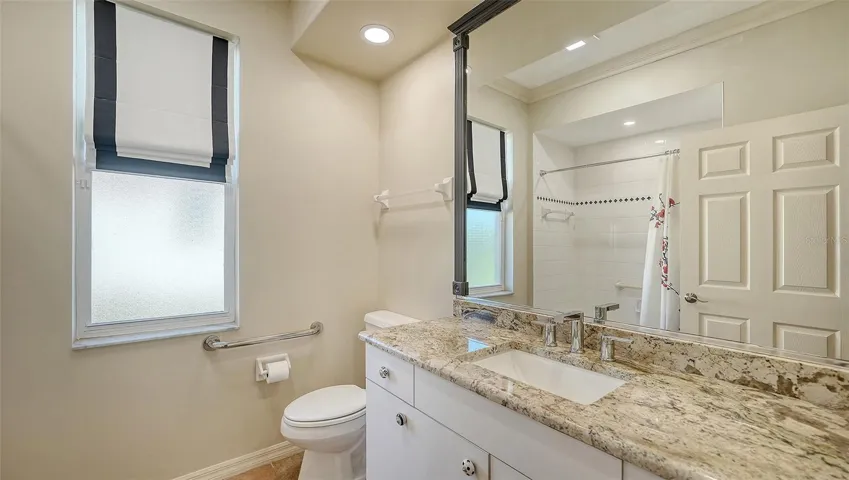 Guest bath, beautiful granite counters, under counter lighting.