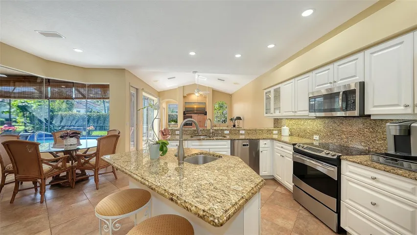 Casual dining dining off the kitchen.  Large aquarium window overlooking lanai and pool.