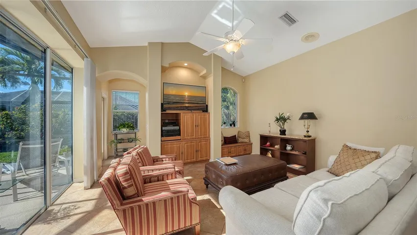 Family room with stylish  windows overlooking back yard, large sliding doors that pocket behind the wall. Great to open up and enjoy the beautiful weather!