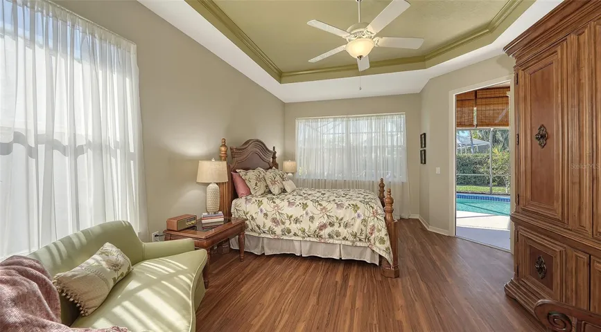 Primary suite with ceiling details, glass door leading to lanai. large windows for great lighting.