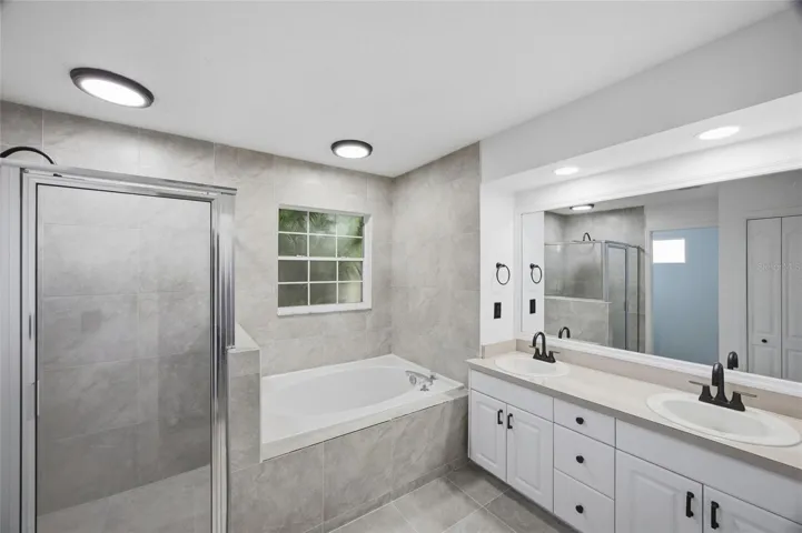 tub and shower and dual sinks