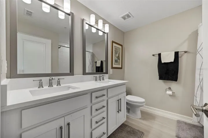 Dual sinks with quartz counters and shaker style cabinets