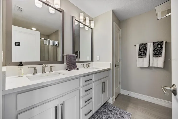 Dual sinks with quartz counters and shaker style cabinets