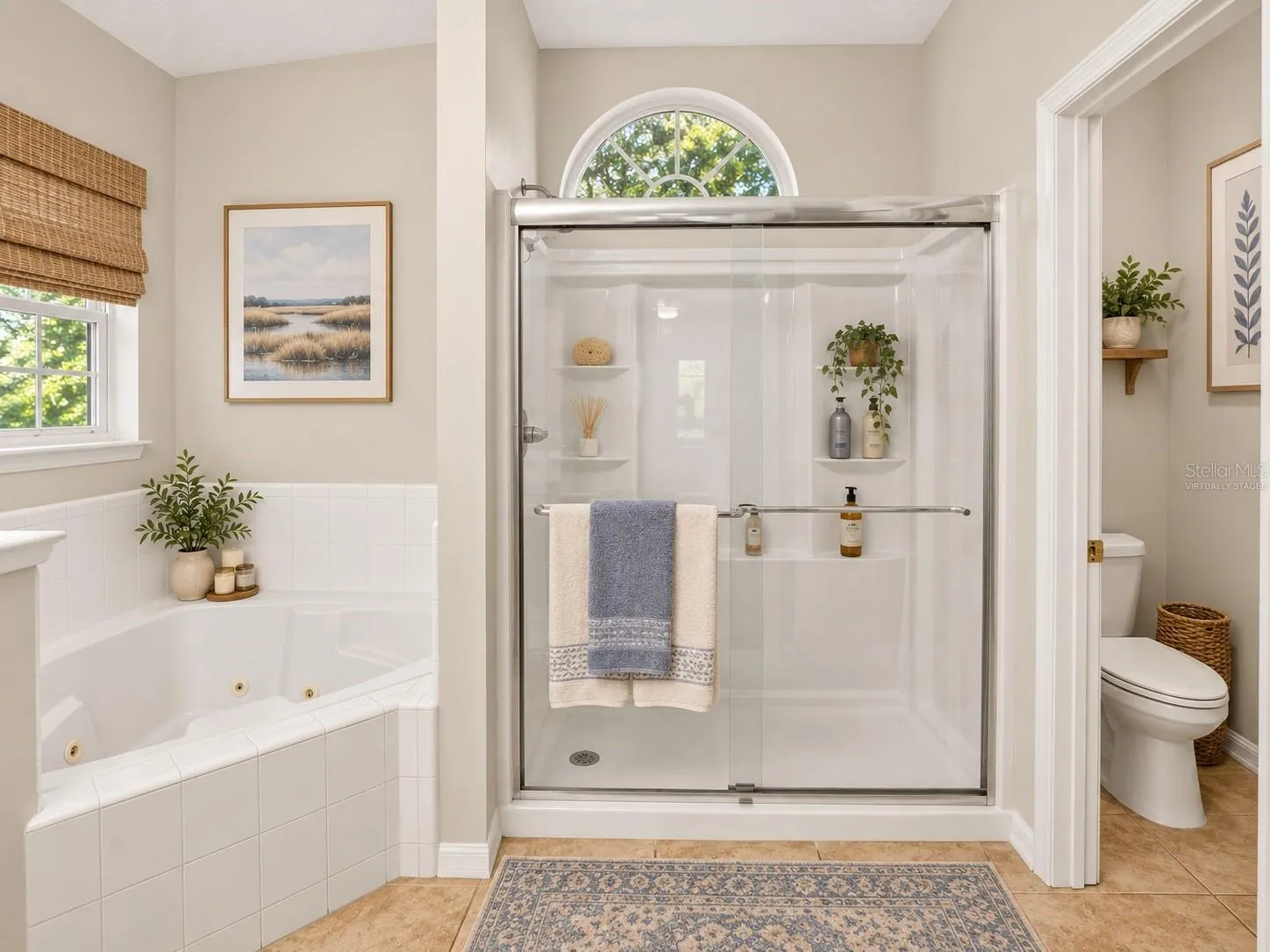 Soaking tub and separate shower in primary bathroom, virtually staged