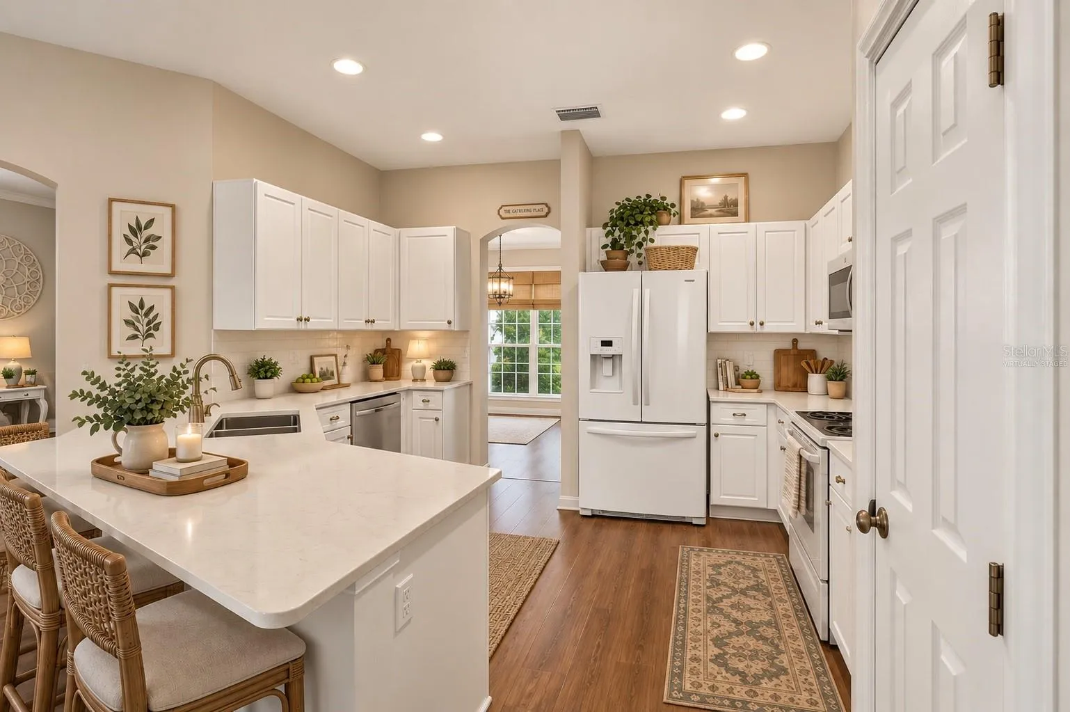 Large kitchen with wood floors, virtually staged
