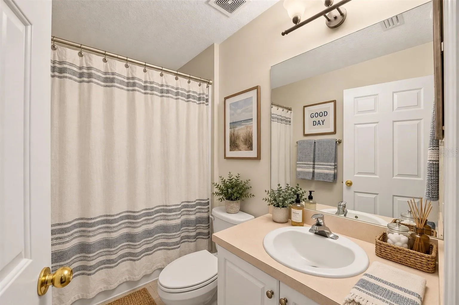 One of three full bathrooms, virtually staged