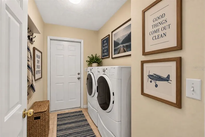 Laundry leading to garage, virtually staged