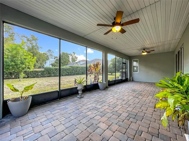 Screened-in back patio with fans