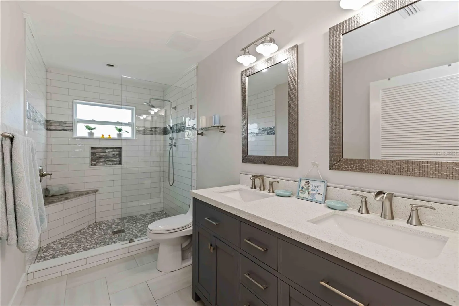 Main level bath w/double bowl sinks and walk in shower