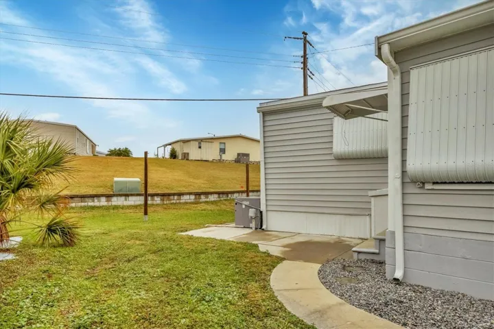 Exterior Side cement sidewalk surrounding home