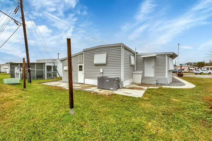 Exterior Back cement sidewalk surrounding home