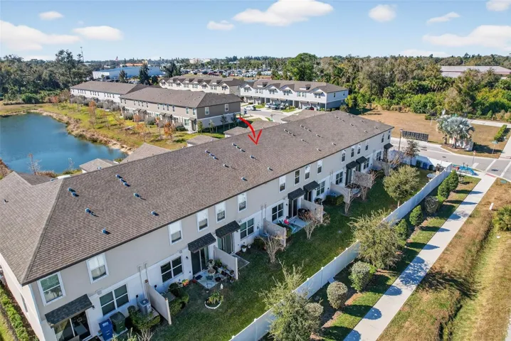 Aerial View shows fence in the back and pond in front