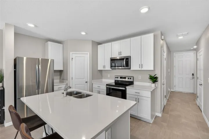 Kitchen with quartz countertops and stainless steel appliances