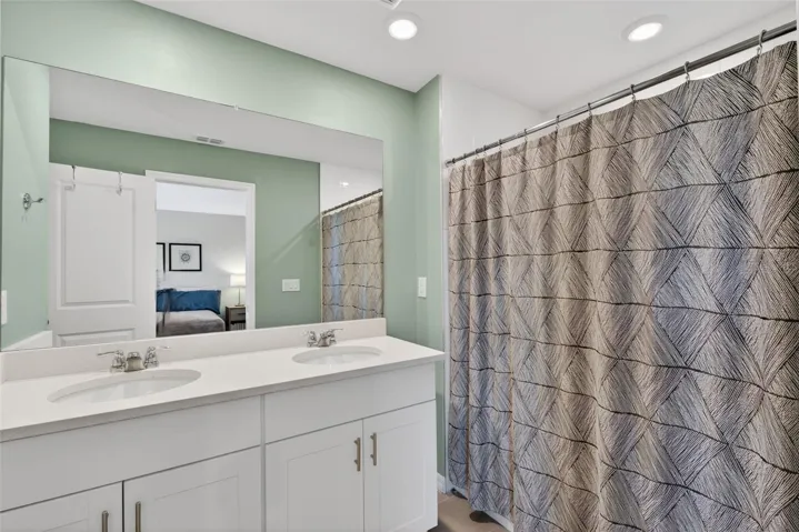 Primary Bathroom with dual sink vanity, walk-in shower, and separate water closet