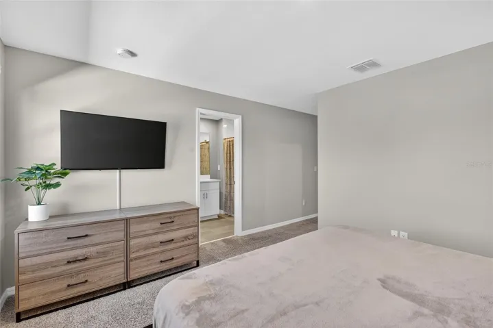 Primary Bedroom with doorway to en-suite bathroom