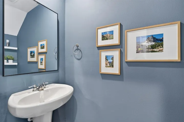 Downstairs half bath located under stairway