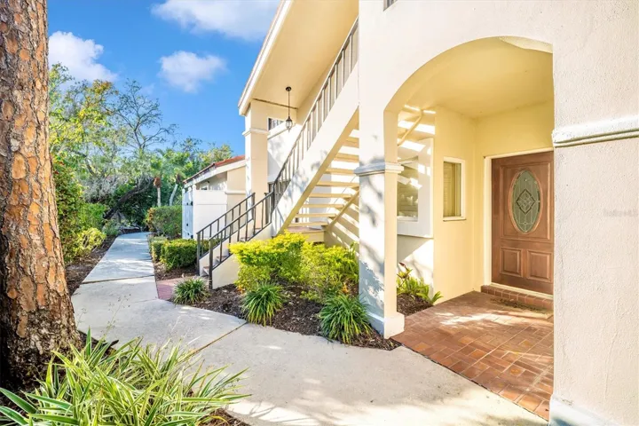 WELCOME to your new 2 bedroom, 2 bathroom, 2 car garage ground level garden style condo. Private outside front door is protected from sun and seasons with porch roof. Clean walkway and mature palm trees.