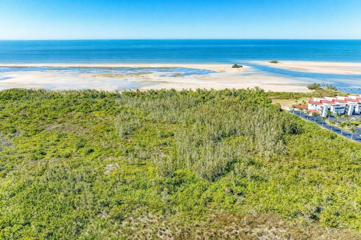 Beachy view at low tide, note channel to gulf