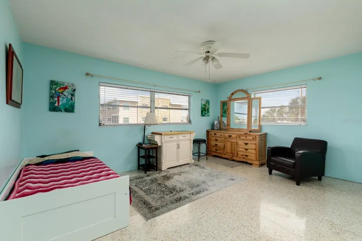 Primary corner bedroom (13'x16'). Terrazzo floor.