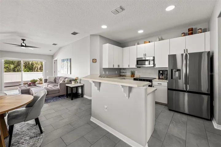 Open kitchen with breakfast bar and connected living space
