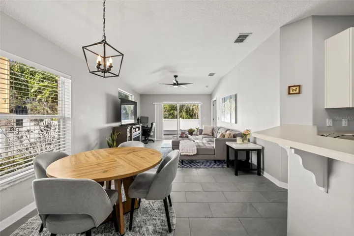 Bright open living and dining area with vaulted ceilings