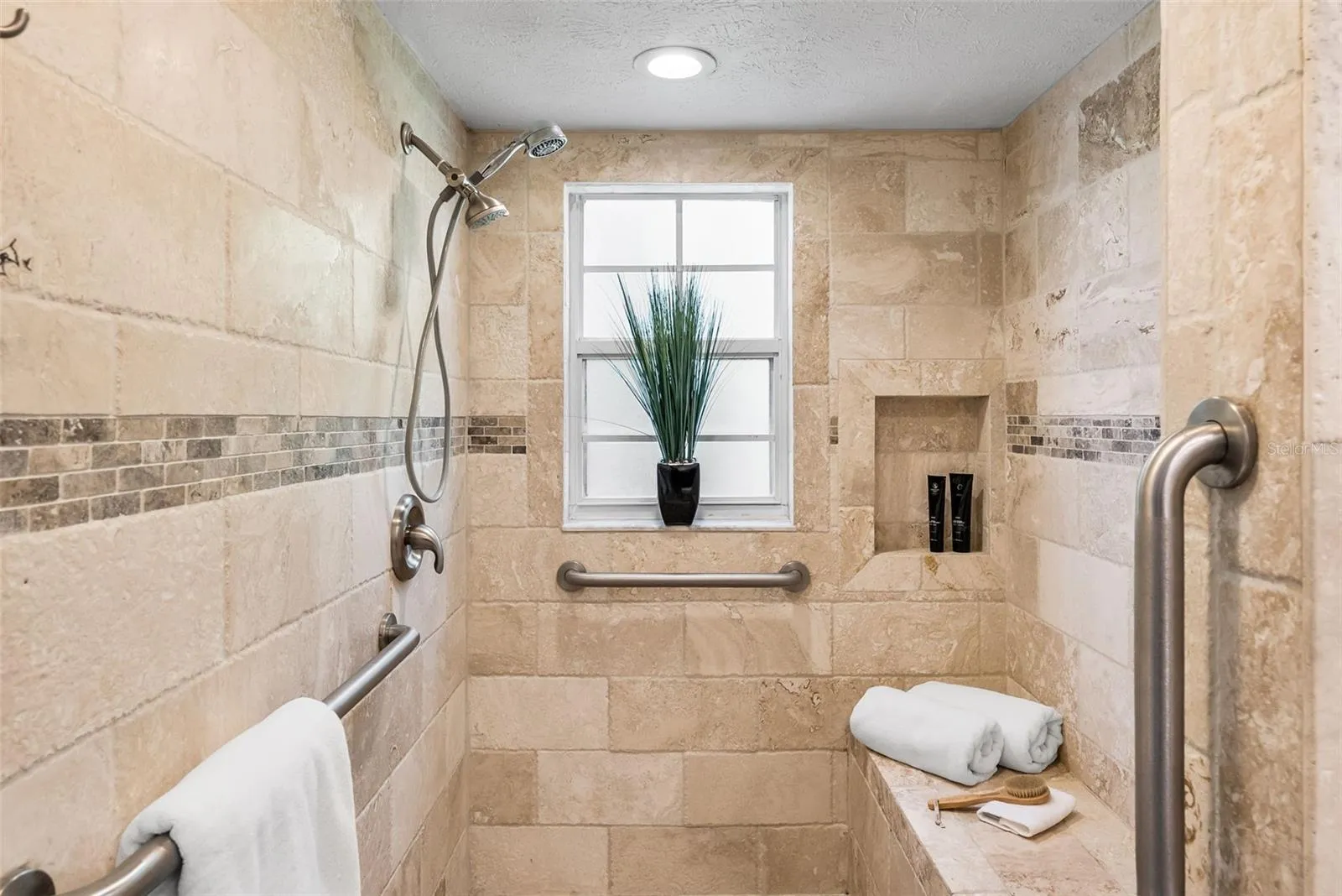 master shower with stone tile