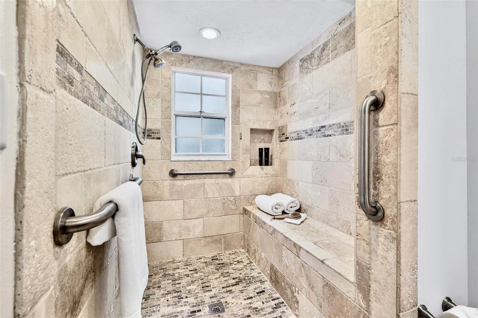Large walk-in shower w/roomy  built-in bench...& no glass to clean!