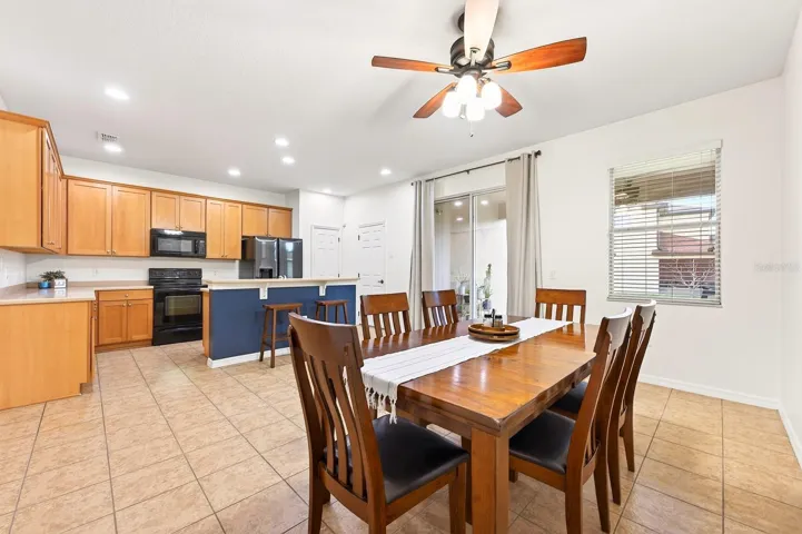 Open kitchen and dining, sliding glass doors open to the covered lanai.