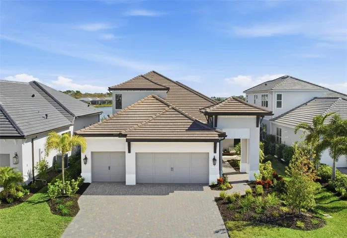 Two story Portofino model with British West Indies elevation with warm contemporary tones, sleek flat concrete tiles and simple elegance that makes it a show stopper!