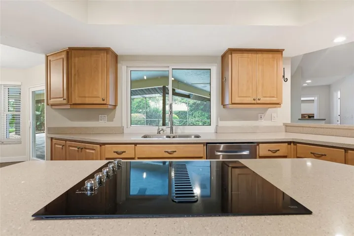 Kitchen overlooks screened pool area
